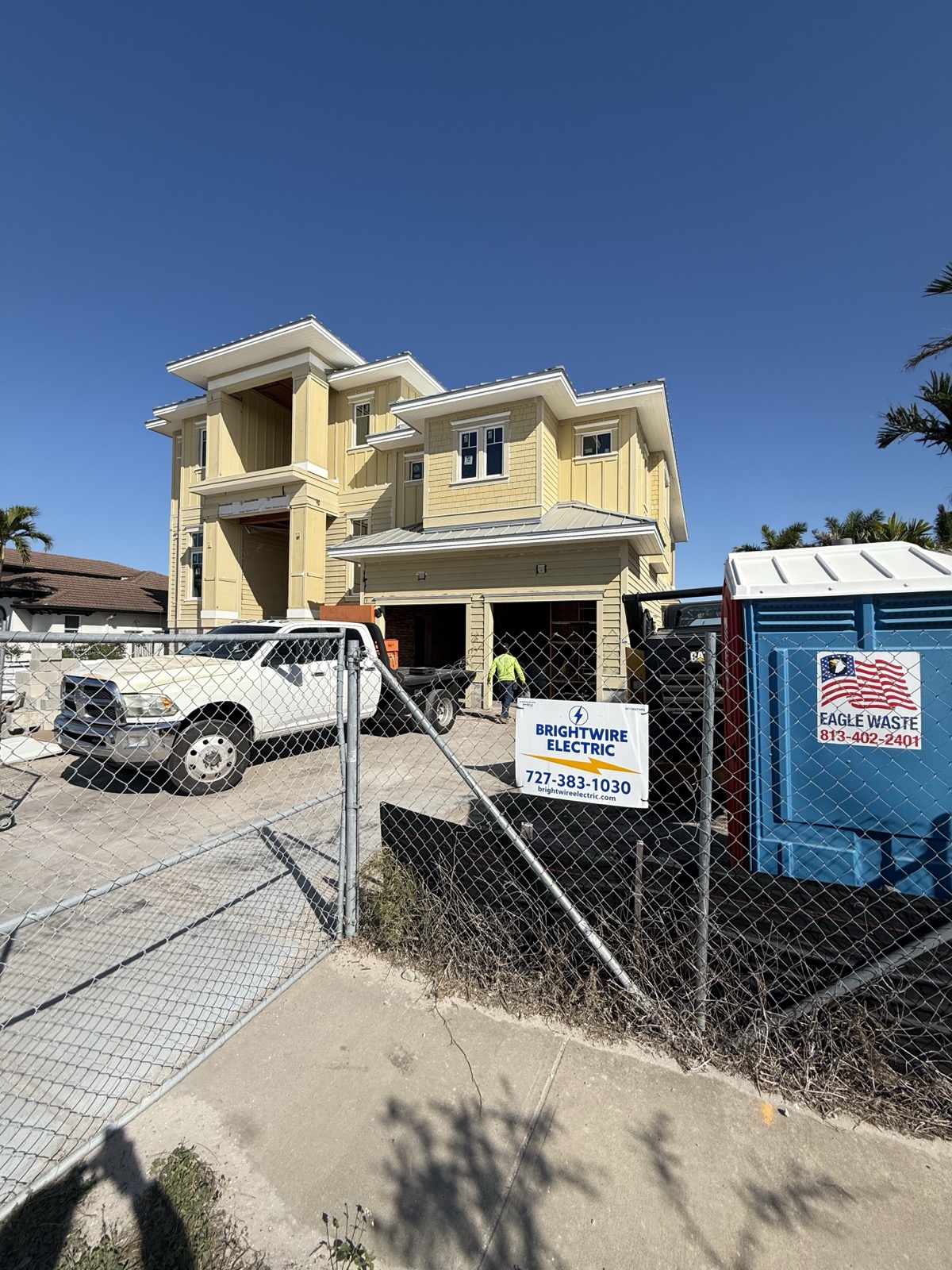 New construction site with Brightwire Electric signage and electrical work in progress